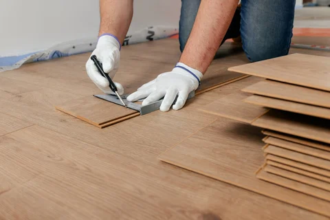 Worker measuring flooring